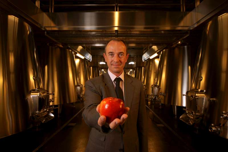 The wine at Cos D'Estournel is moved from grape to bottle purely by gravity, hence Jean Guillaume Prats is photographed with an apple. The apple also represents through Isaac Newton, the connection with the British and the Bordeaux wine industry. And there is the aspect of temptation; Jean Guillaume entices us away from all other wines with the magical allure of Cos D'Estournel.